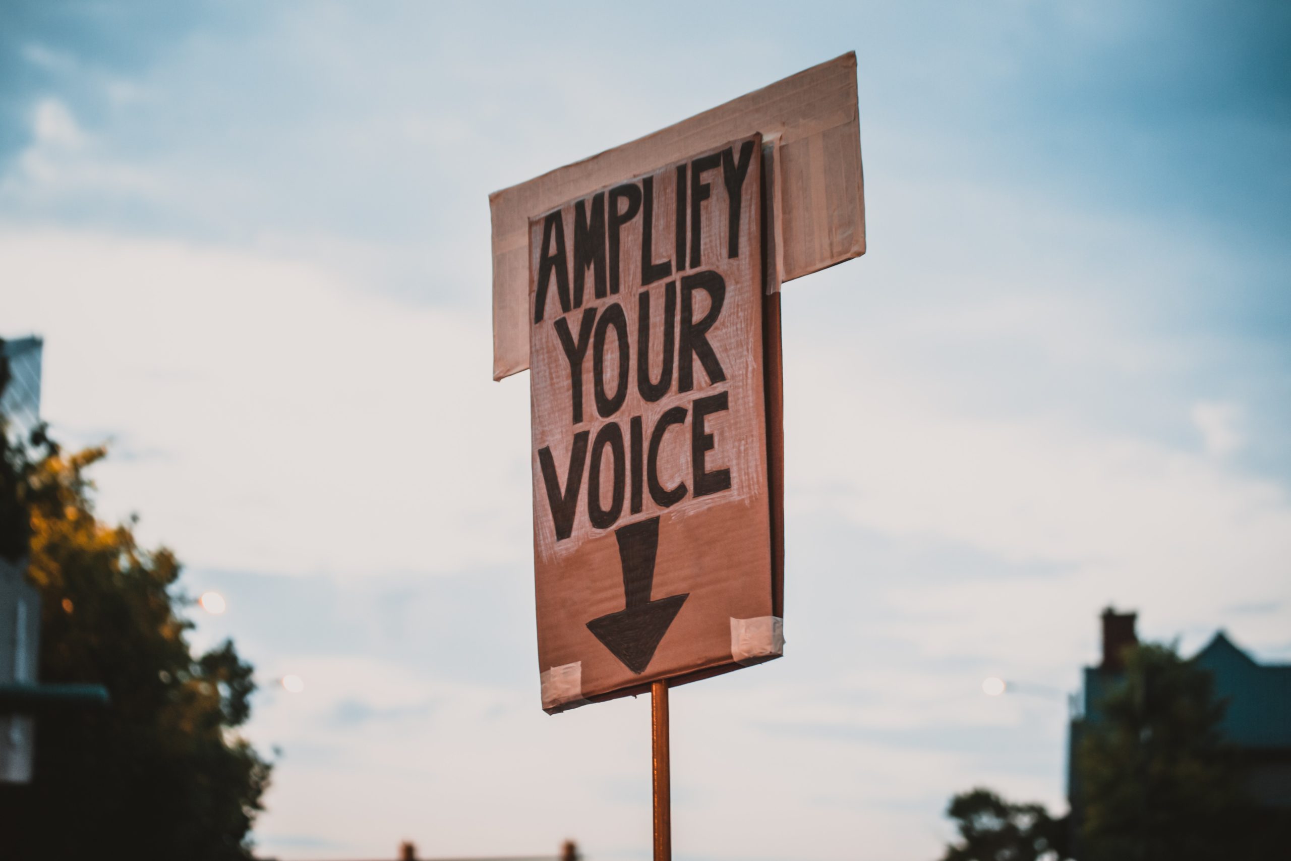 Sign that says "amplify your voice"